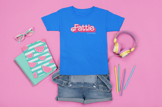 An outfit laid out with a blue shirt that reads Fattie in pink in a font similar to Barbie